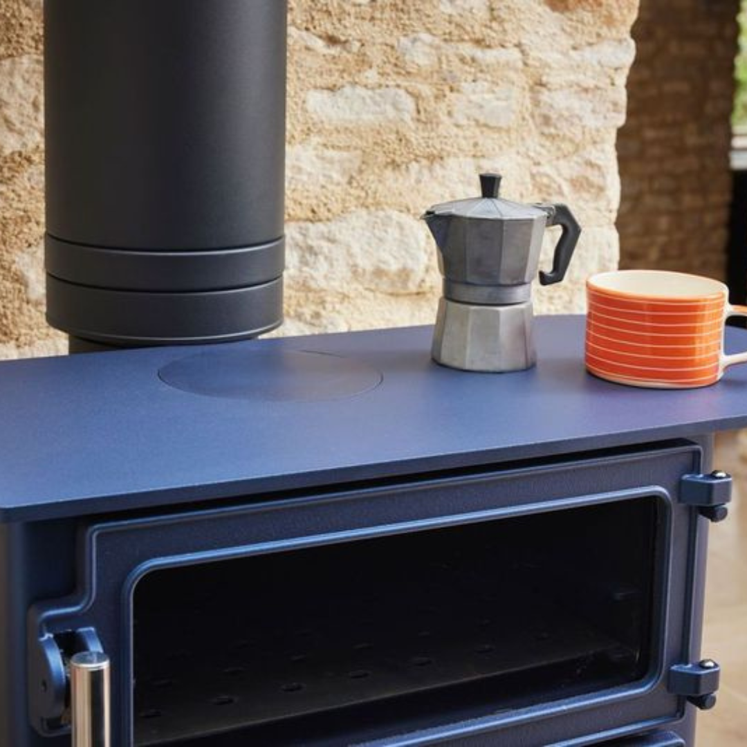 Traditional stone hearth with wood-burning stove in Cornwall cottage