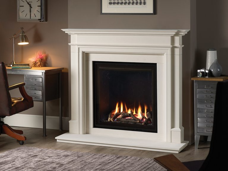 Elegant stone fire surround installed around a wood-burning stove in Cornwall